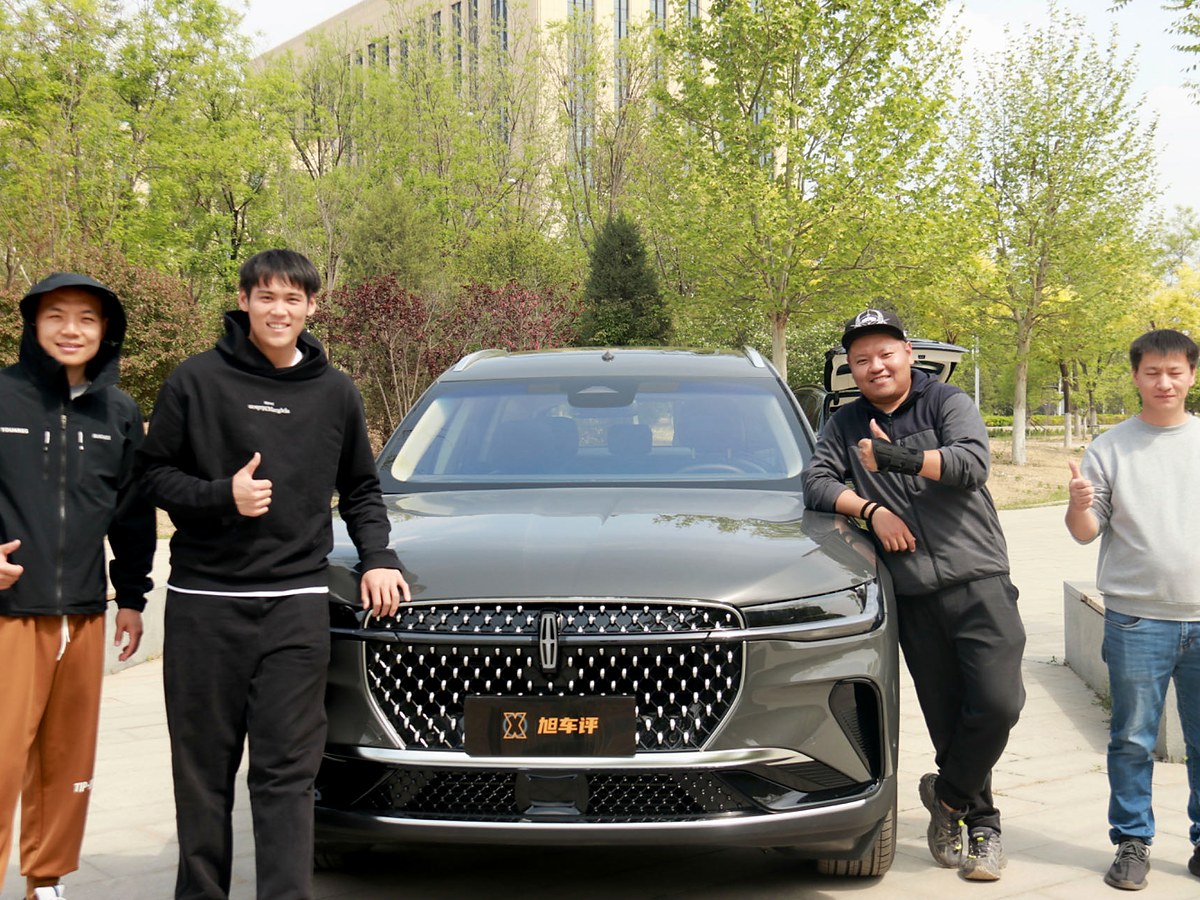 Adam Zhang with the production crew and the Lincoln Nautilus