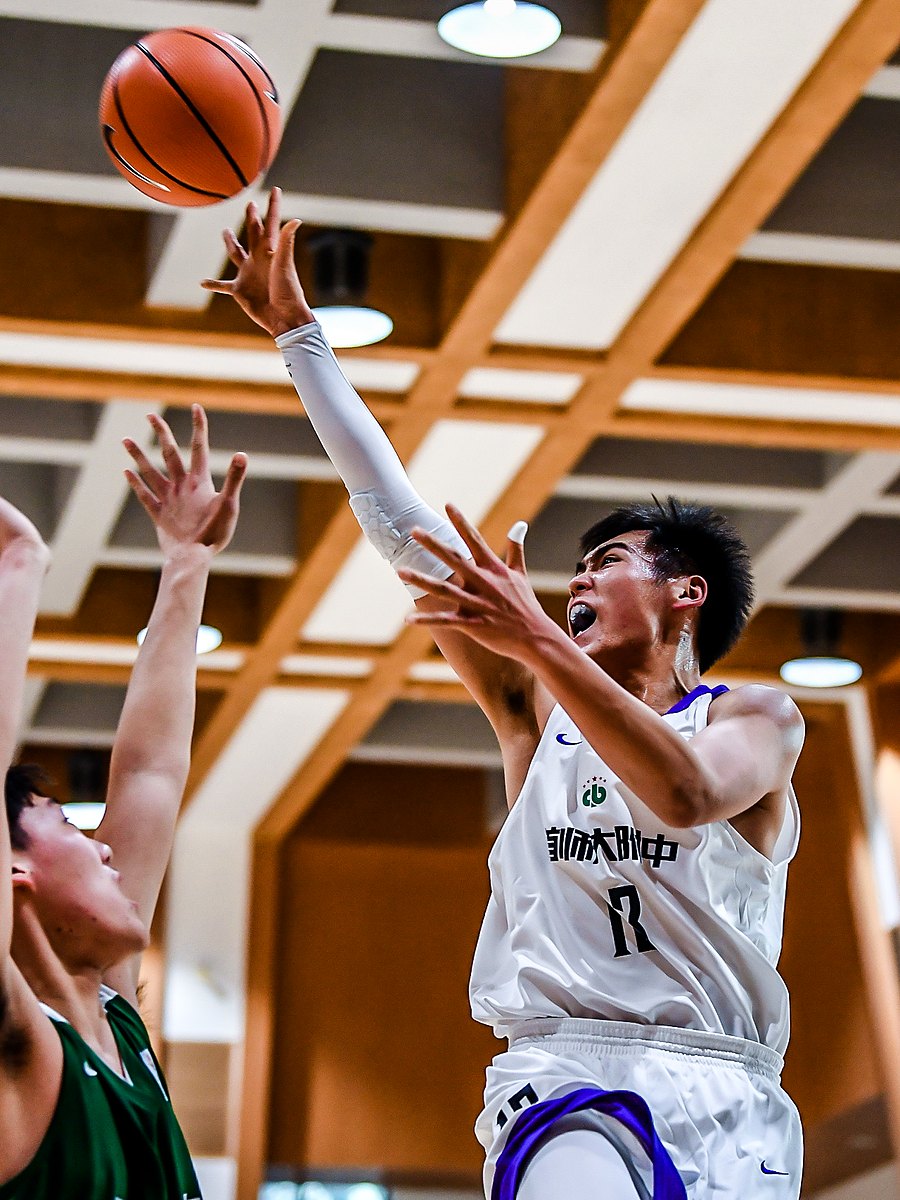 Adam Zhang going up for a layup over two defenders in the 2020 CHBL semifinal