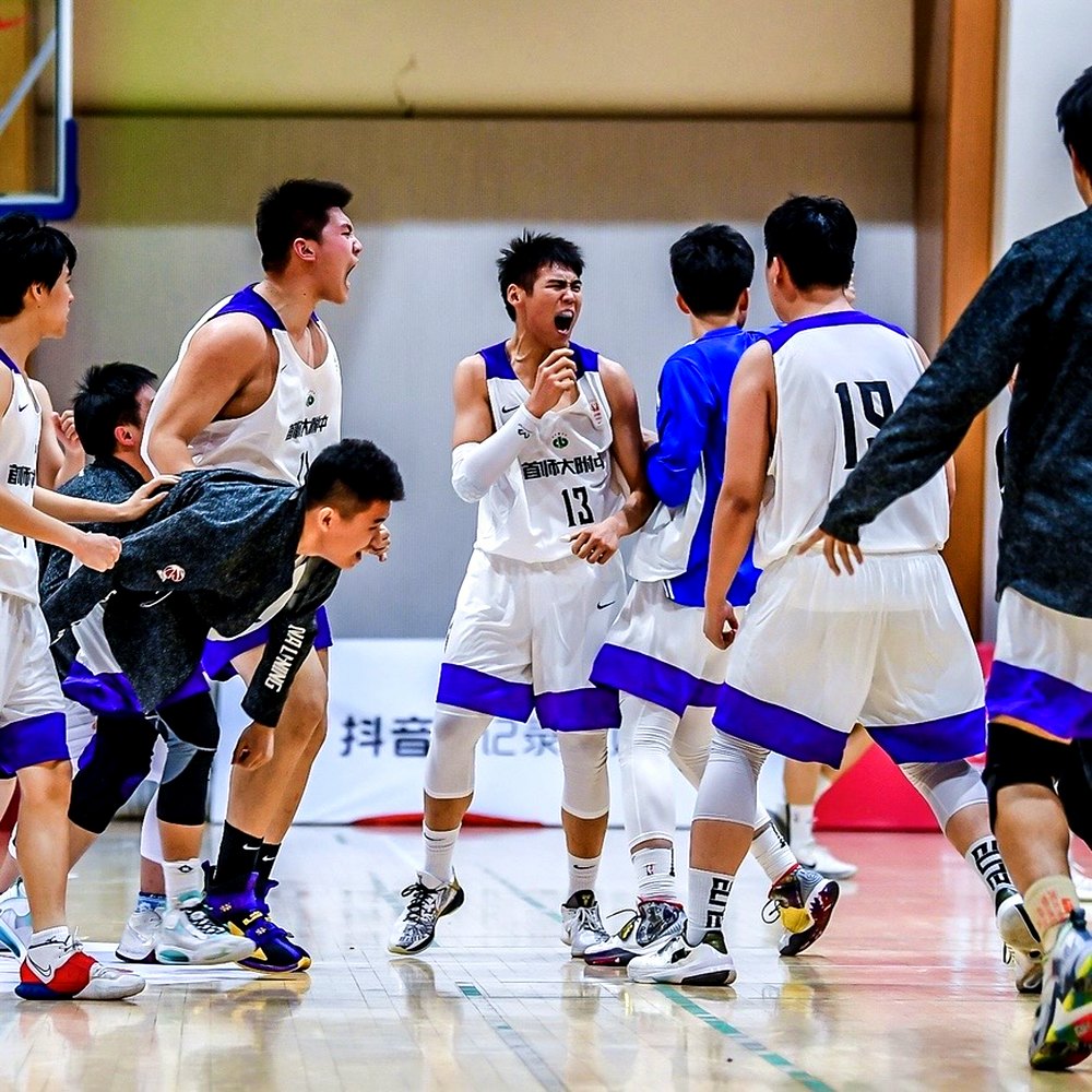 Adam Zhang, number 13, celebrating with his high-school team on court in a CHBL Beijing game